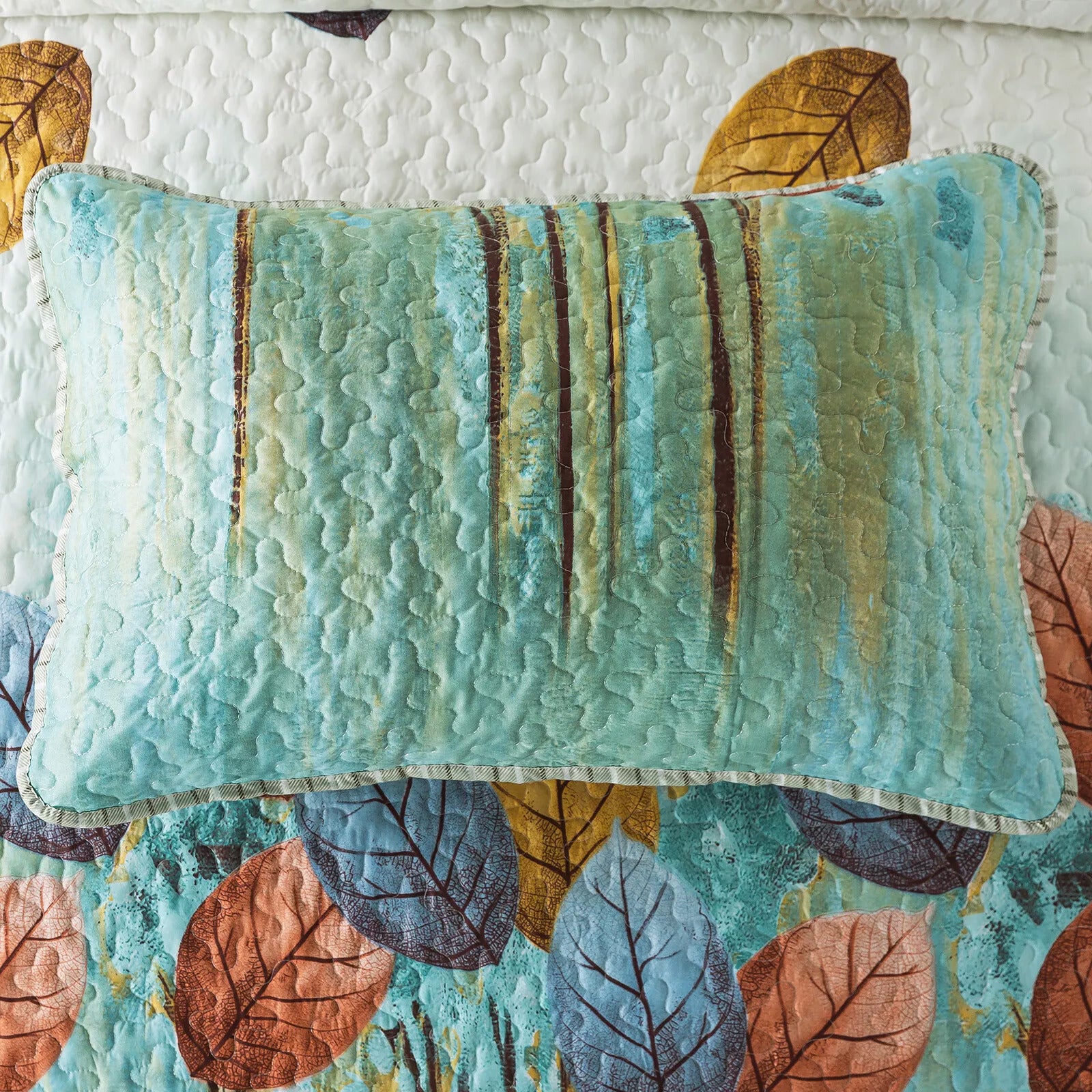 Majestic Quilted bedspread and pillowcovers set: Enhance Your Sleep Experience - Queen size with blue patterned pillow on leaf print quilt