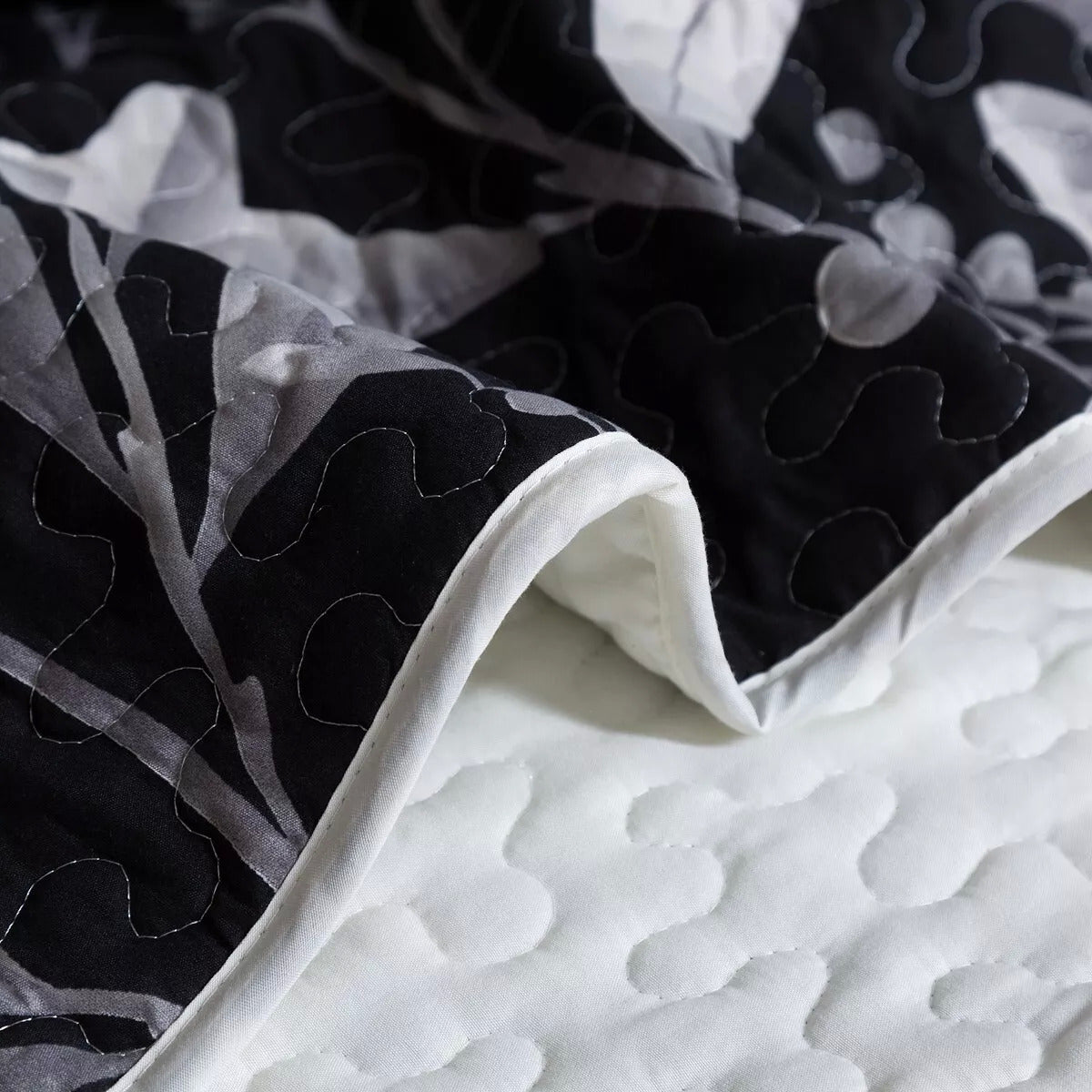 Whimsical Quilted bedspread and pillowcovers set: Add Fun to Your Space - Queen size with black and white reversible quilting detail close-up