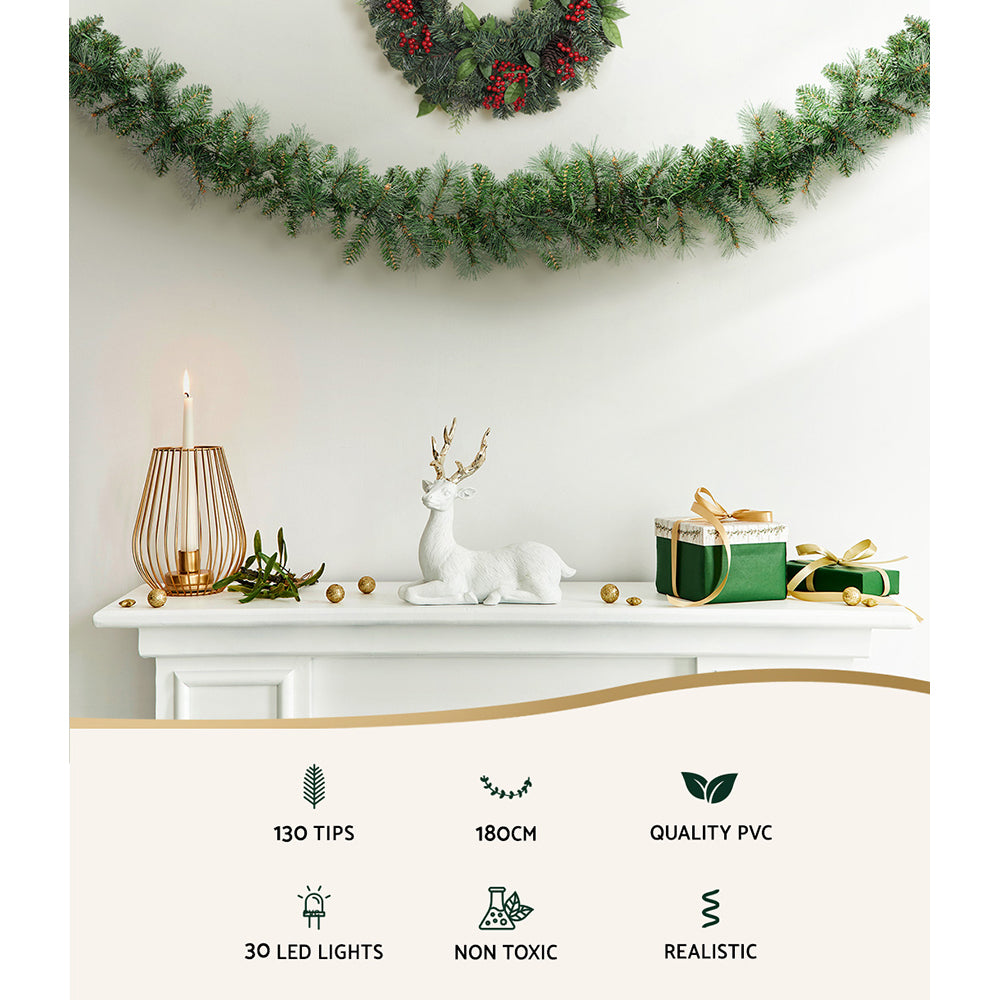 1.8m Christmas Garland with LED lights Party Xmas Decorations hung above mantel with candle, deer figure, and wrapped gifts on white shelf