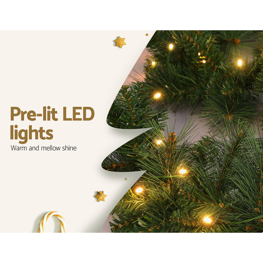 1.8m Christmas Garland with LED lights Party Xmas Decorations featuring warm white pre-lit bulbs on green foliage close-up