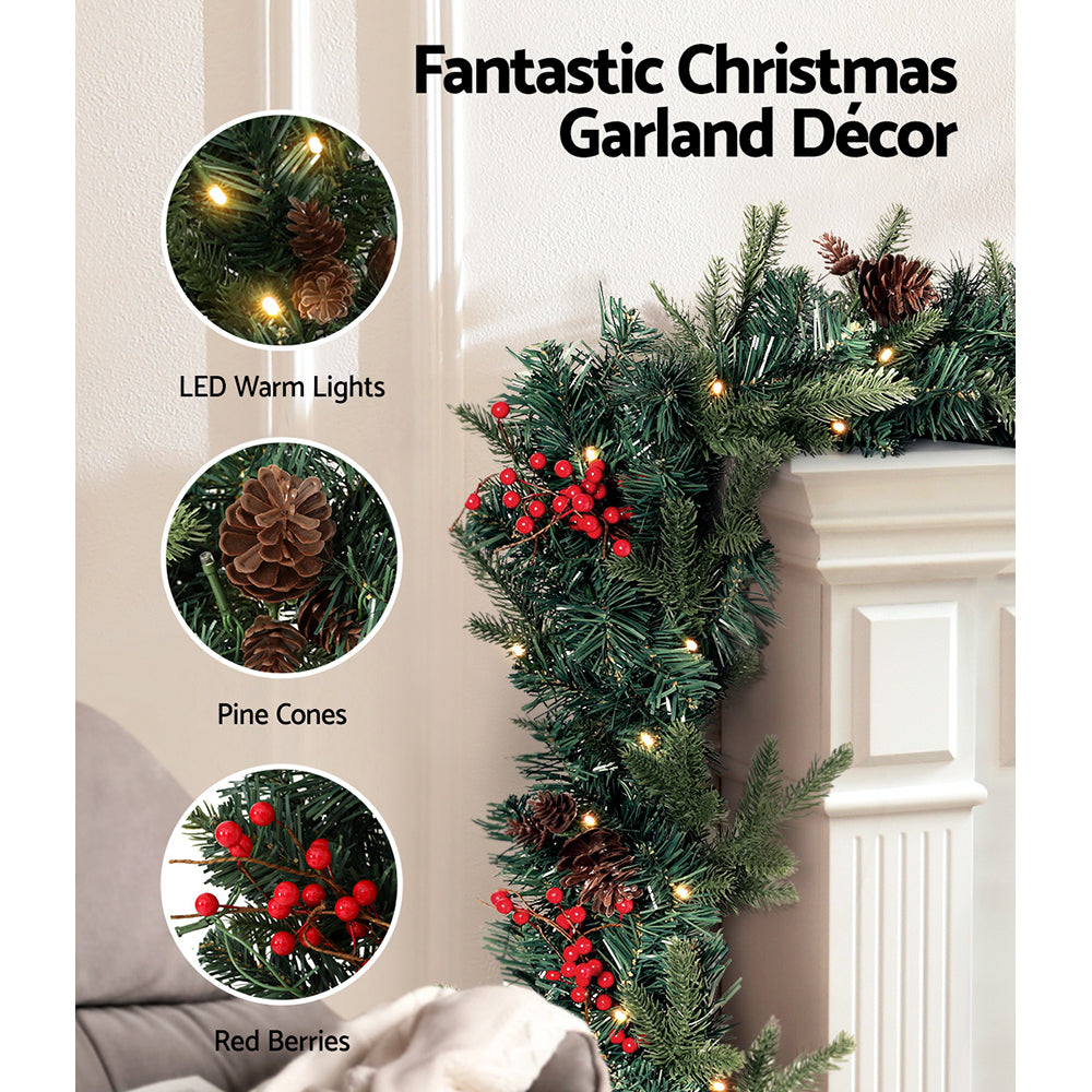 2.4m Christmas Garland with LED Lights Decorations Xmas Party featuring warm lights, pine cones, and red berries on mantel decor