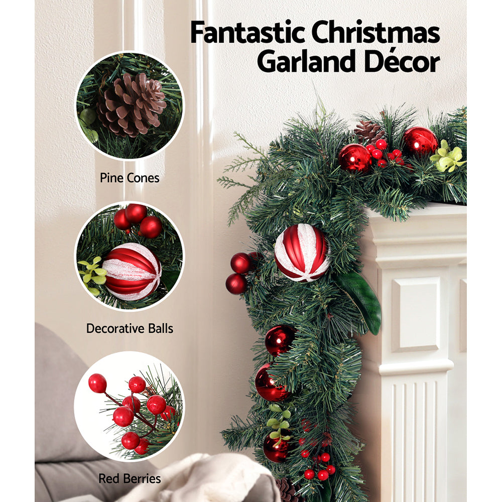 2.7m Christmas Garland with Decorations Xmas Wedding Party featuring pine cones, decorative balls, and red berries on mantelpiece