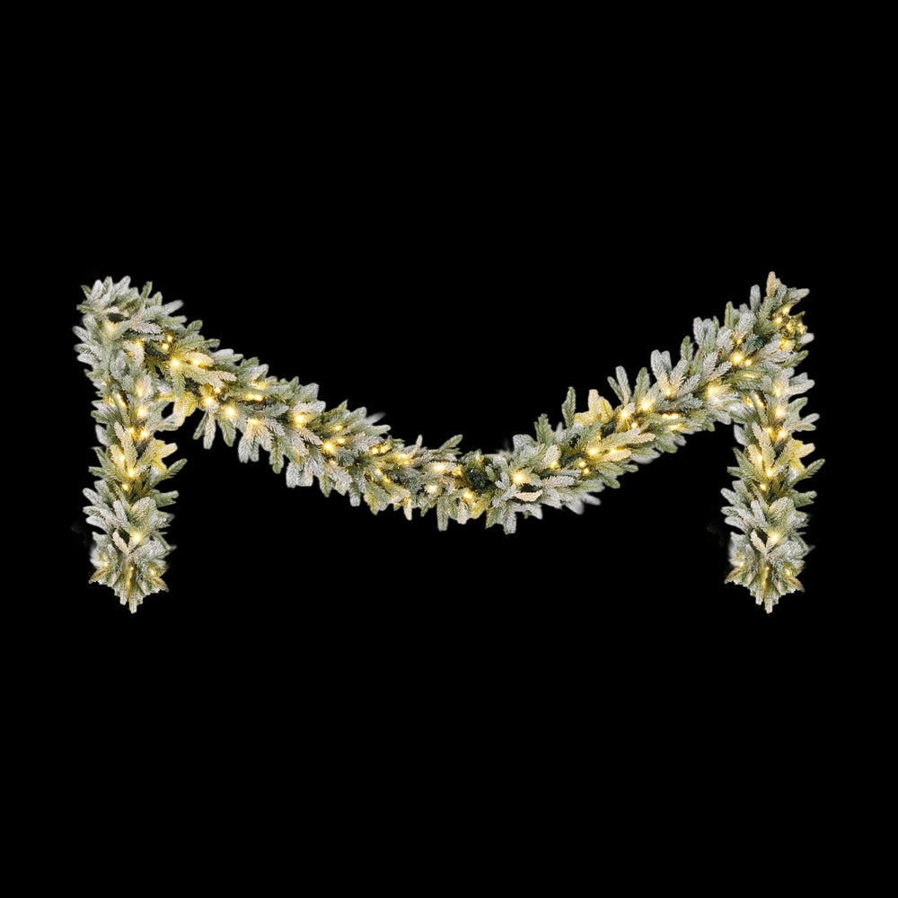 3M Christmas Garland Pre-lit LED Lights Snow Frosted Tips Decor with warm white LED lights on frosted greenery against black background