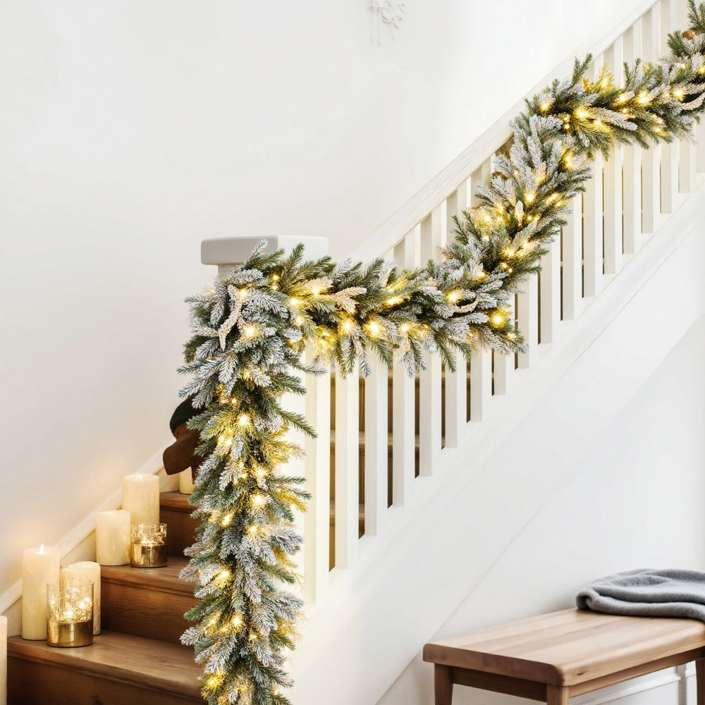 3M Christmas Garland Pre-lit LED Lights Snow Frosted Tips Decor on staircase banister with warm glowing lights