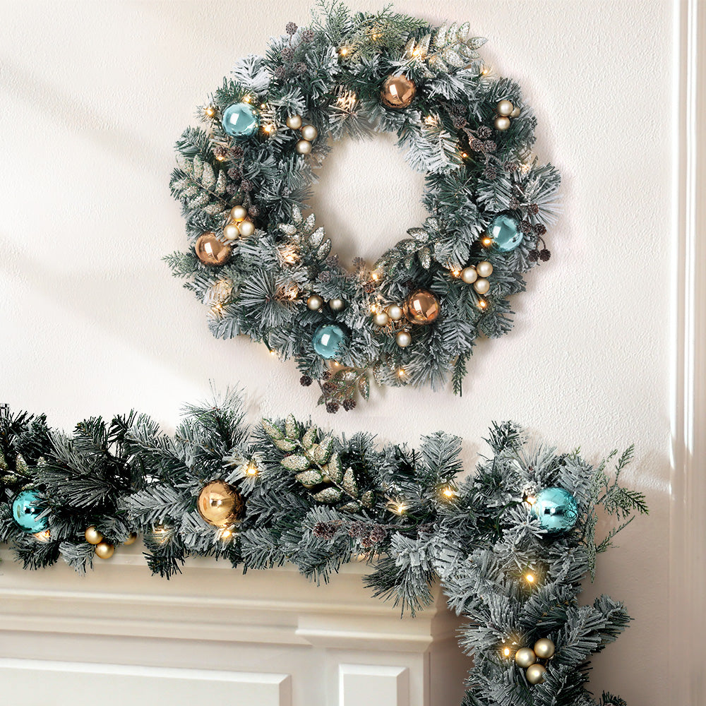 2.7m Christmas Garland with Wreath Set LED Lights Snowy Xmas Decor with blue and gold ornaments on mantel