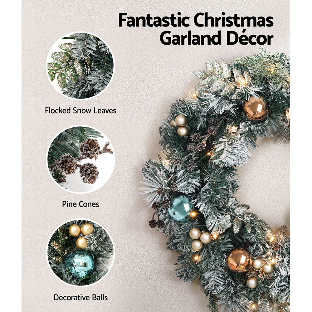60cm Christmas Wreath with LED Lights Snowy Garland Xmas Decor featuring pine cones, flocked leaves, and decorative balls on wall