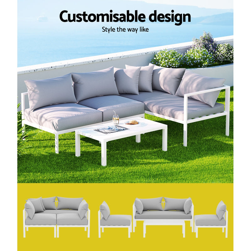 Airlie 4 Seat Aluminium Outdoor Sofa and Table Set White with light cushions on green grass and ocean view background