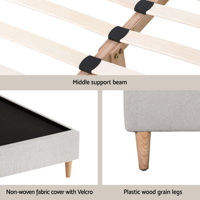 Zora Double Bed Frame Base Beige showing wooden slats with middle support, fabric cover, and plastic wood grain legs.