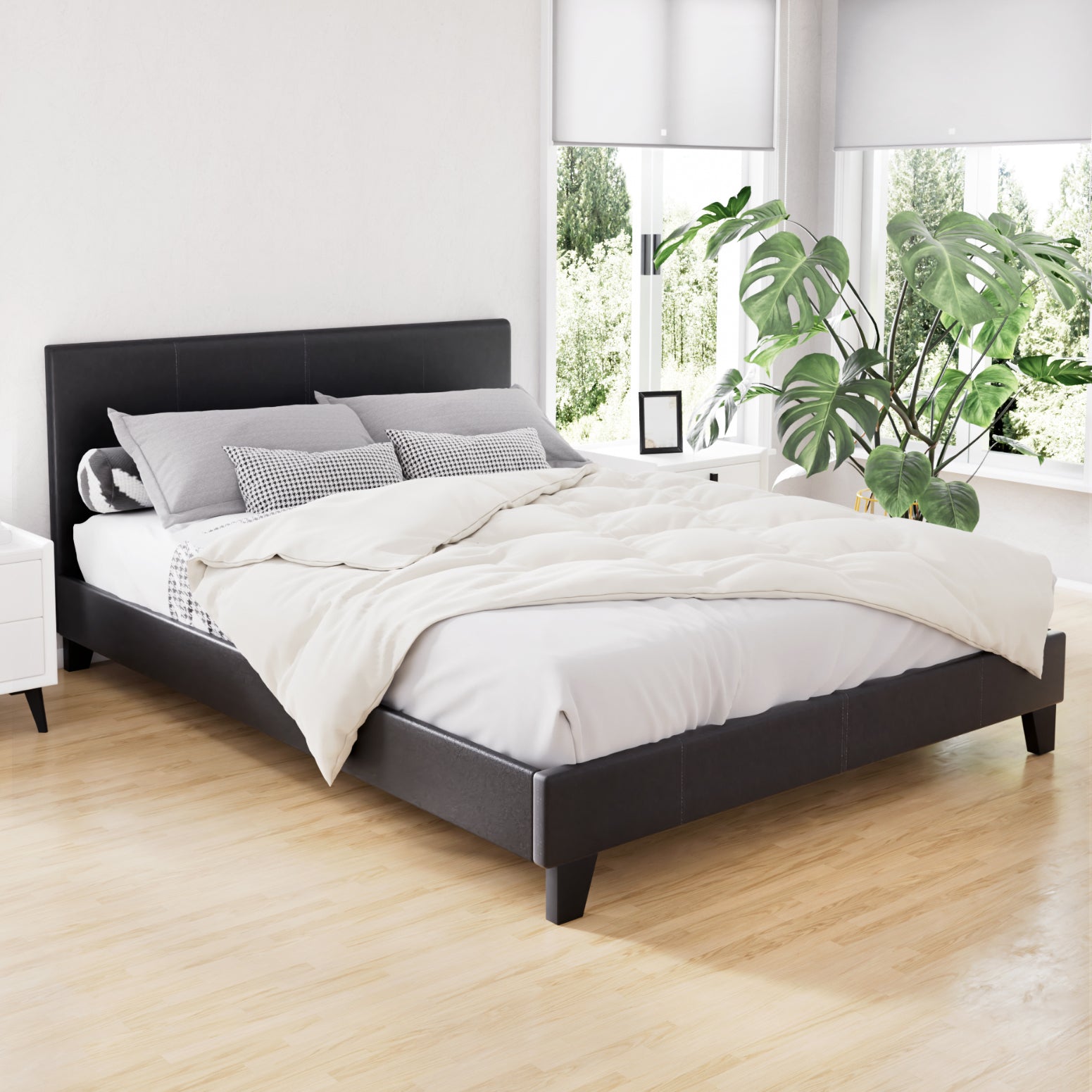 Coogee Double Bed Frame Black in PVC leather with padded headboard, set in modern bedroom with natural light and plants.