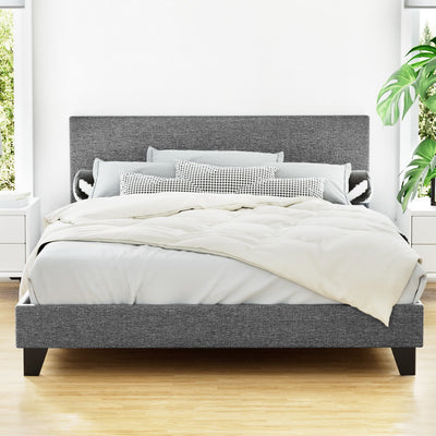 Coogee Queen Bed Frame Grey with upholstered headboard and wooden legs, styled with white bedding in bright bedroom setting