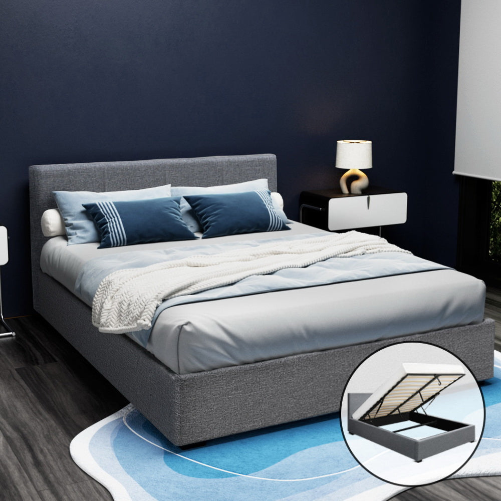 Elwood Gas Lift Storage Queen Bed Frame Grey with padded headboard, upholstered base, and gas lift storage mechanism shown in modern bedroom setting