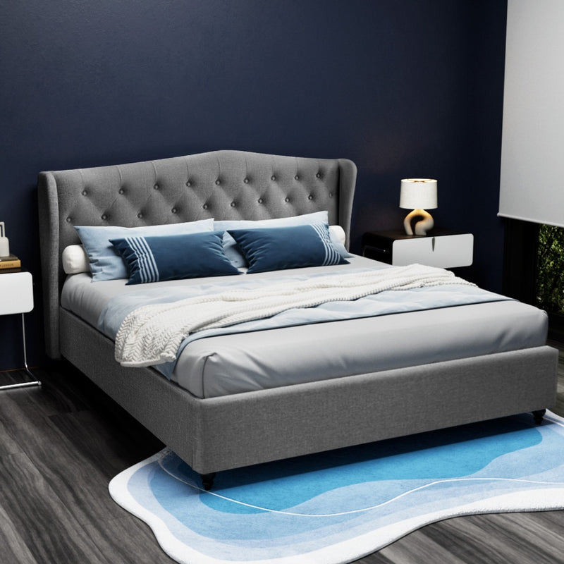 Altona King Bed Frame Grey with tufted winged headboard, upholstered frame, styled with blue and white bedding in bedroom setting