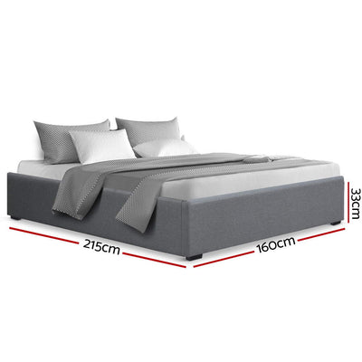 Toki Gas Lift Queen Bed Frame Base with Storage Grey, upholstered grey fabric, with pillows and bedding on white background