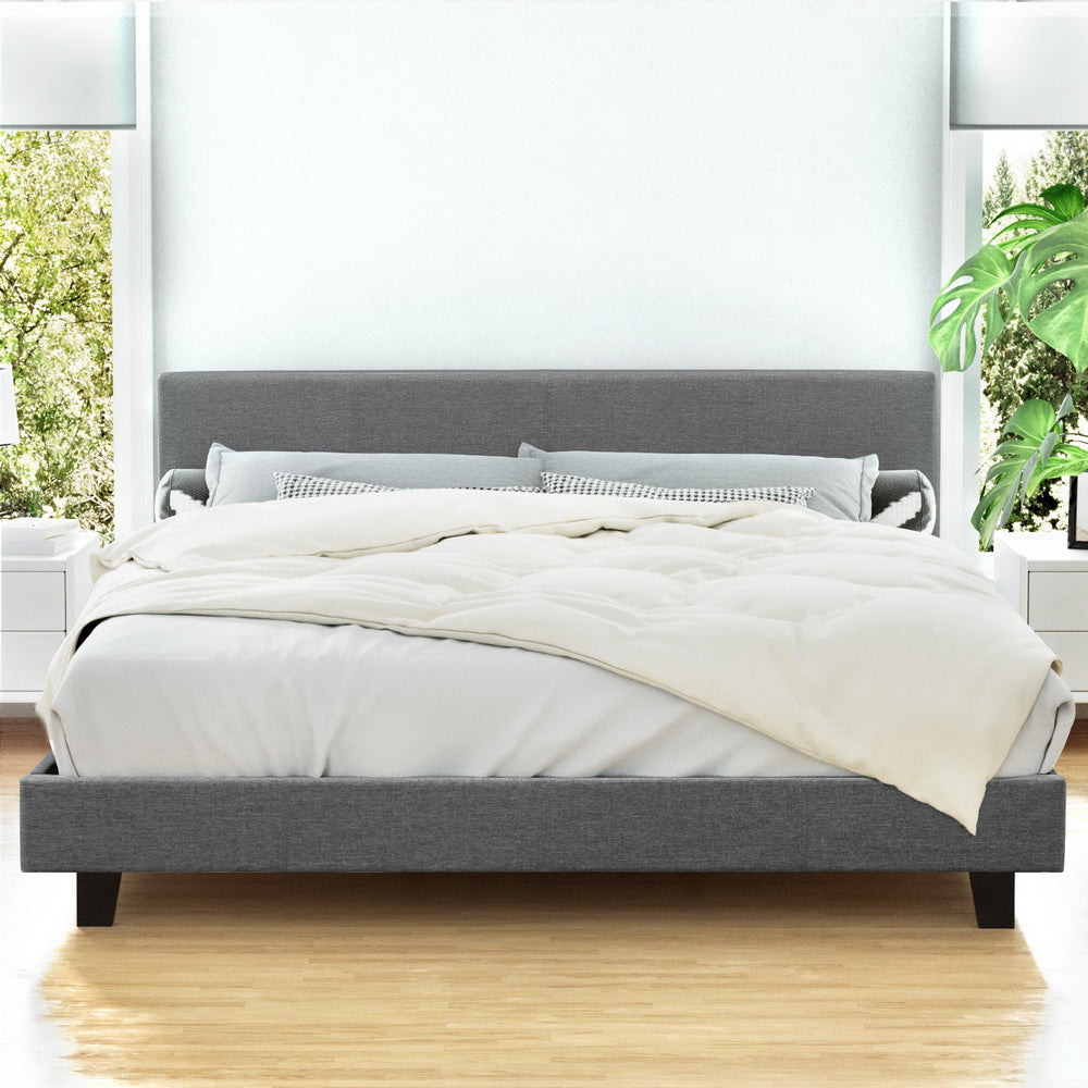 Coogee King Bed Frame Grey with upholstered headboard, wooden slats, and neutral bedding in bright bedroom setting