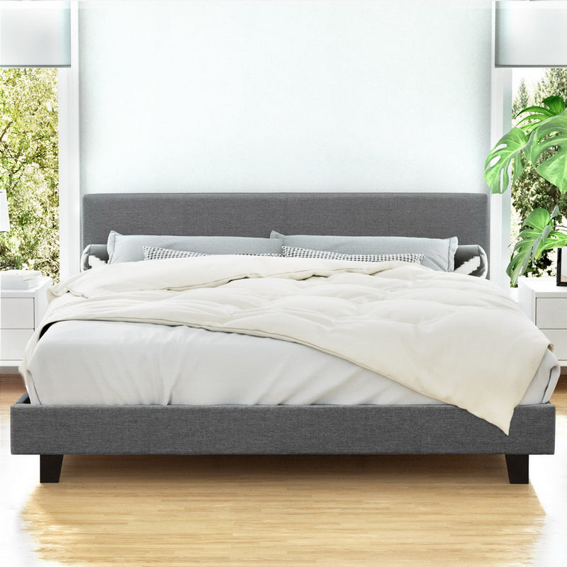 Coogee King Bed Frame Grey with upholstered headboard, wooden slats, and neutral bedding in bright bedroom setting
