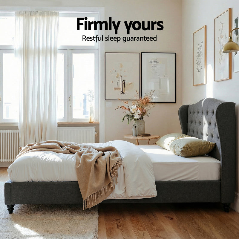 Pierre Queen Bed Frame with Wingback Headboard – Charcoal in a bright bedroom setting with beige bedding and decorative pillows