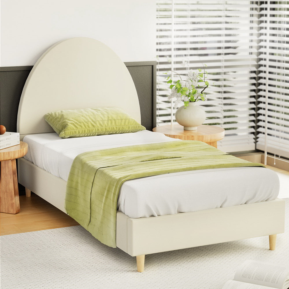 Ella Arched Single Bed Frame Cream Velvet with curved headboard, wooden legs, green bedding, and natural light setting
