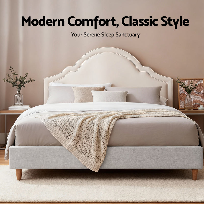 Iris Queen Bed with Scalloped Velvet Headboard – Beige in bedroom setting with neutral bedding and wooden legs