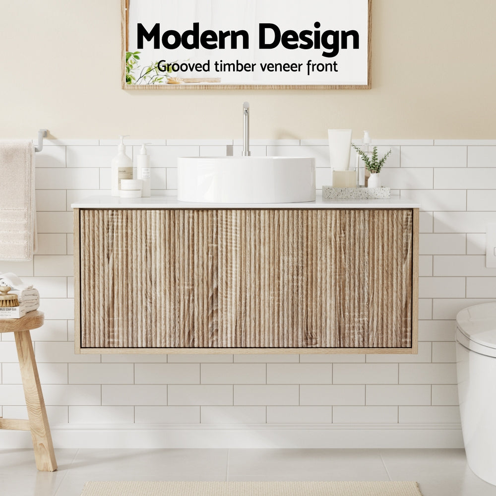 Vanity Unit 915mm with Basin Oak featuring grooved timber veneer front, wall-hung design, and modern white basin on tiled bathroom wall