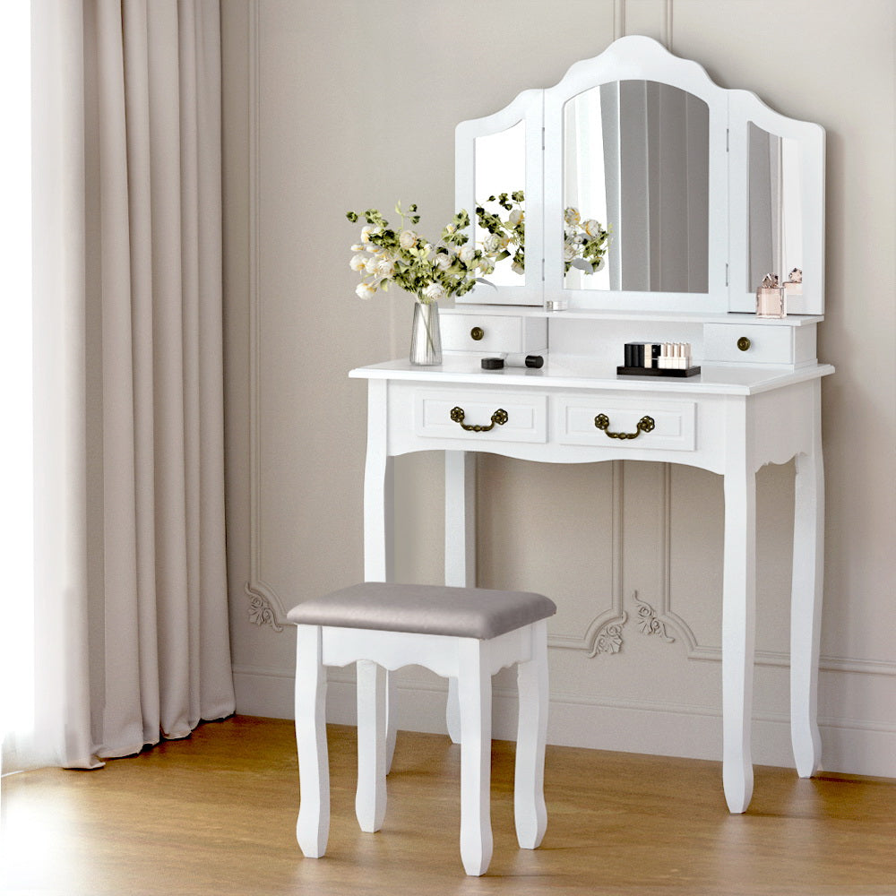 Dressing Table with Mirror - White featuring three mirrors, two drawers with brass handles, cushioned stool, and decorative vase on top