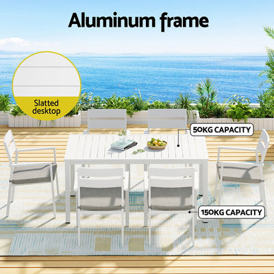 7 Piece Aluminium Outdoor Dining Set White With Grey Cushions featuring slatted white table and six grey cushioned chairs outdoors