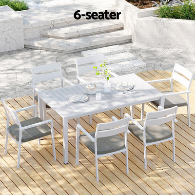 7 Piece Aluminium Outdoor Dining Set White With Grey Cushions featuring six chairs and a rectangular table on wooden deck outdoors