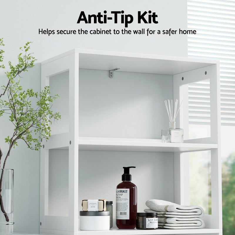 Bathroom Floor Storage Cabinet with 2 Drawers 3 Open Shelves 2 Doors White showing anti-tip kit securing cabinet to wall with bathroom items on shelves