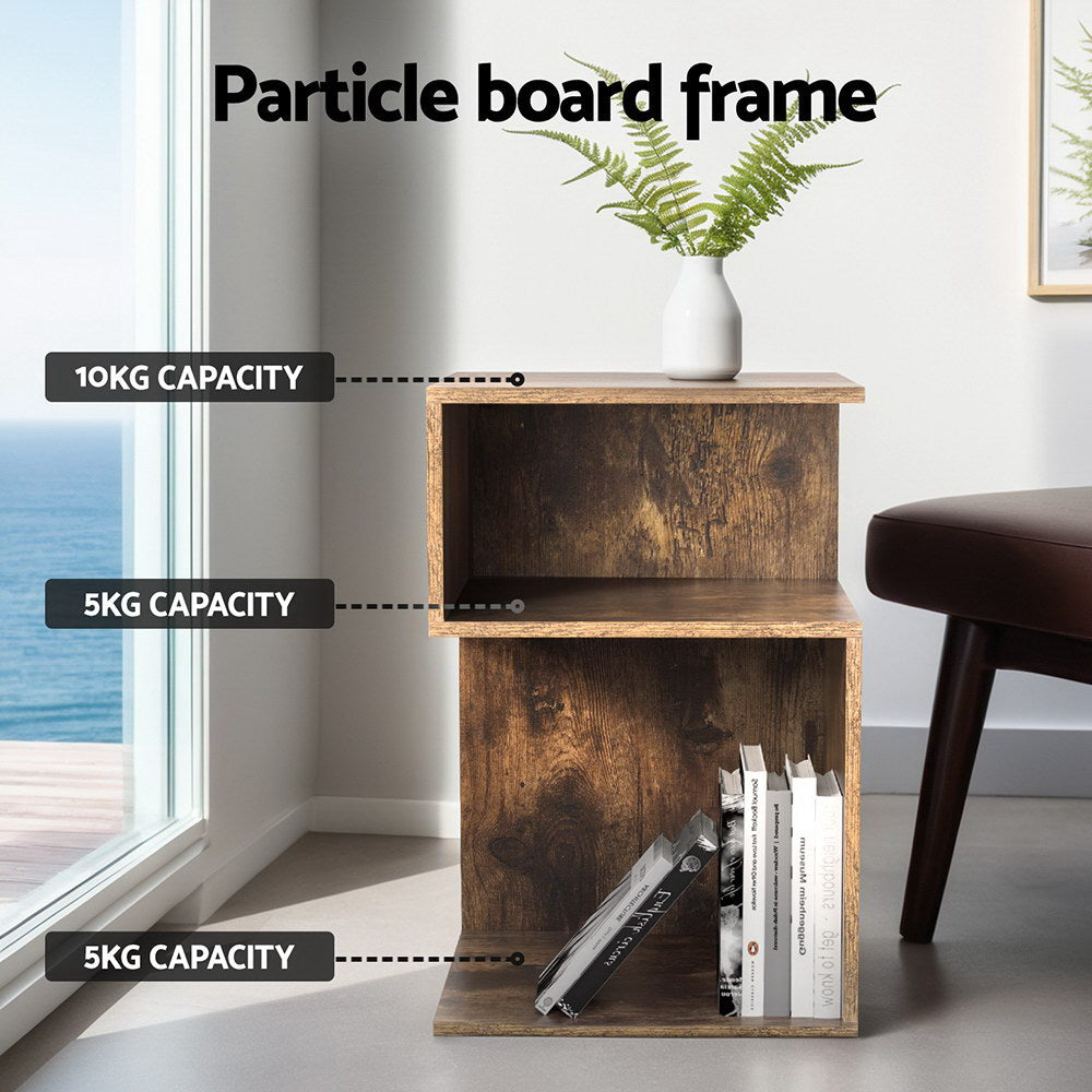 Artistic Bedside Table - Rust Oak with particle board frame, open shelving, and weight capacity labels in a bright room setting