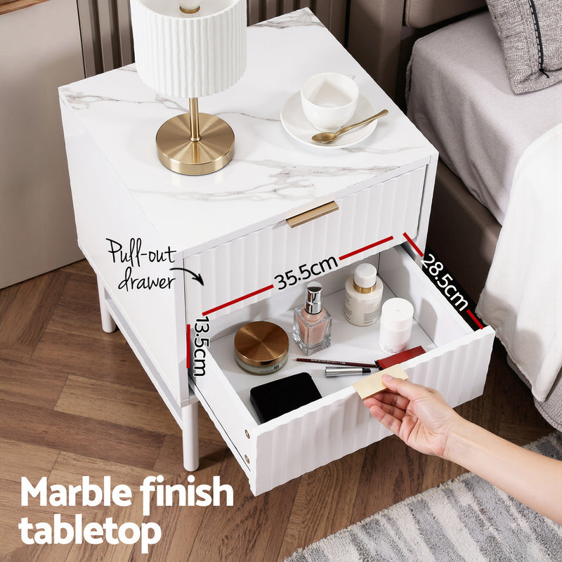 Bedside Table 2 Drawers - White with marble finish tabletop, textured front drawers, styled in bedroom setting with lamp and cup.