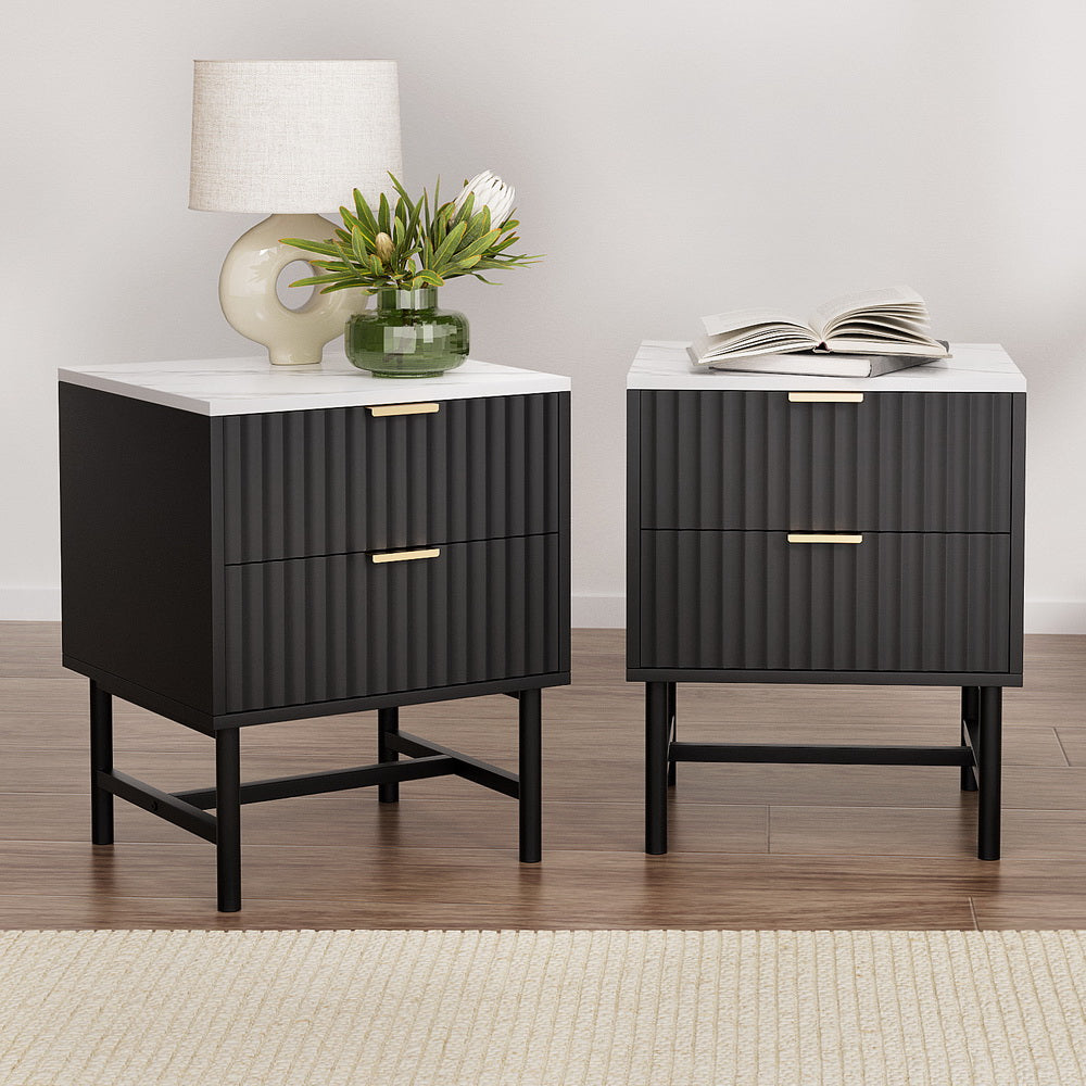 2x Bedside Table 2 Drawers - Black with ribbed drawer fronts, white tops, gold handles, and black metal legs in bedroom setting