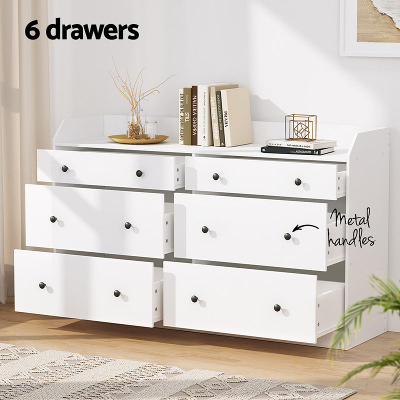 6 Chest of Drawers - PETE White with six spacious drawers, metal handles, and a high-density particleboard frame in bedroom setting