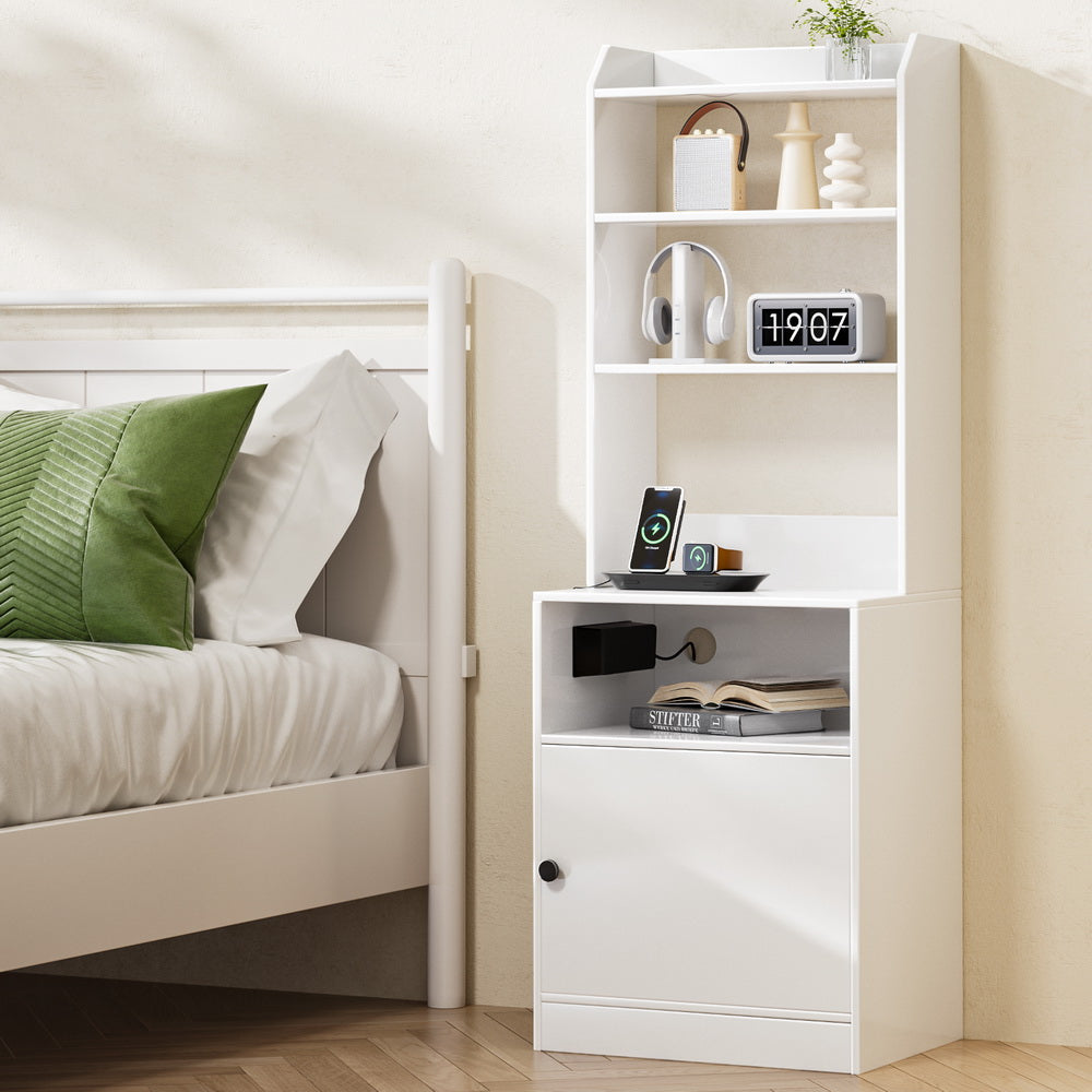 Bedside Table Nightstand with Charging Station - White with shelves, storage cabinet, and phone charging on bedside in bedroom setting