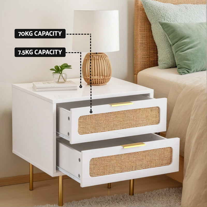 Byron Rattan Bedside Table – White & Pine with rattan drawers, gold legs, holding lamp and plant in bedroom setting