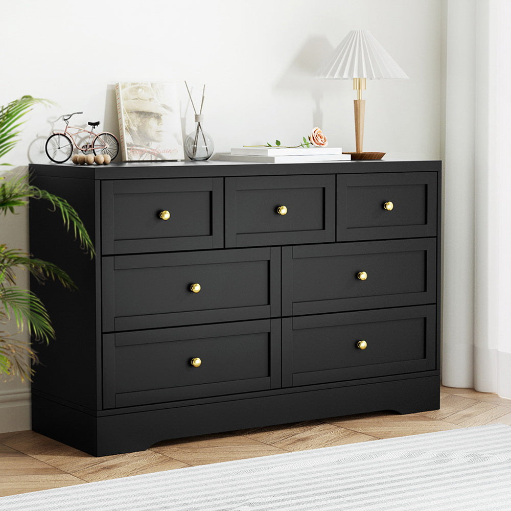 7-Drawer Chest of Drawers with Metal Handles - Black in a modern bedroom setting with decorative items on top