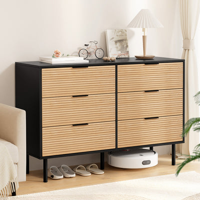 6 Chest of Drawers Dresser Table Black&Pine with fluted doors, metal handles, six drawers, and raised legs in a bedroom setting