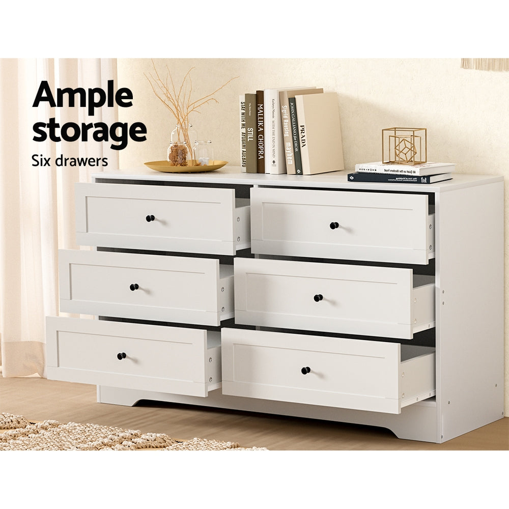 6 Drawer Classic Style Lowboy - White with six open drawers, black knobs, and decorative items on top in a bedroom setting