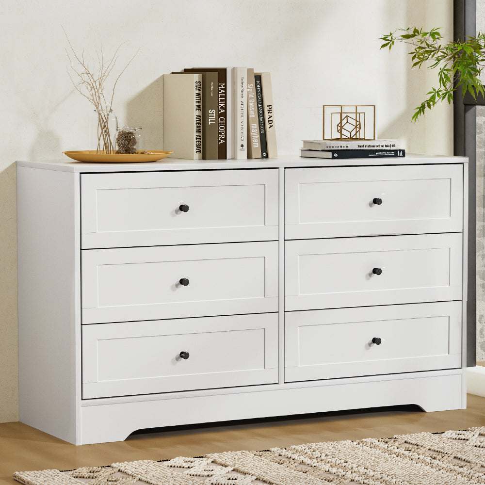 6 Drawer Classic Style Lowboy - White with black knobs, styled with books and decorative items in a bedroom setting