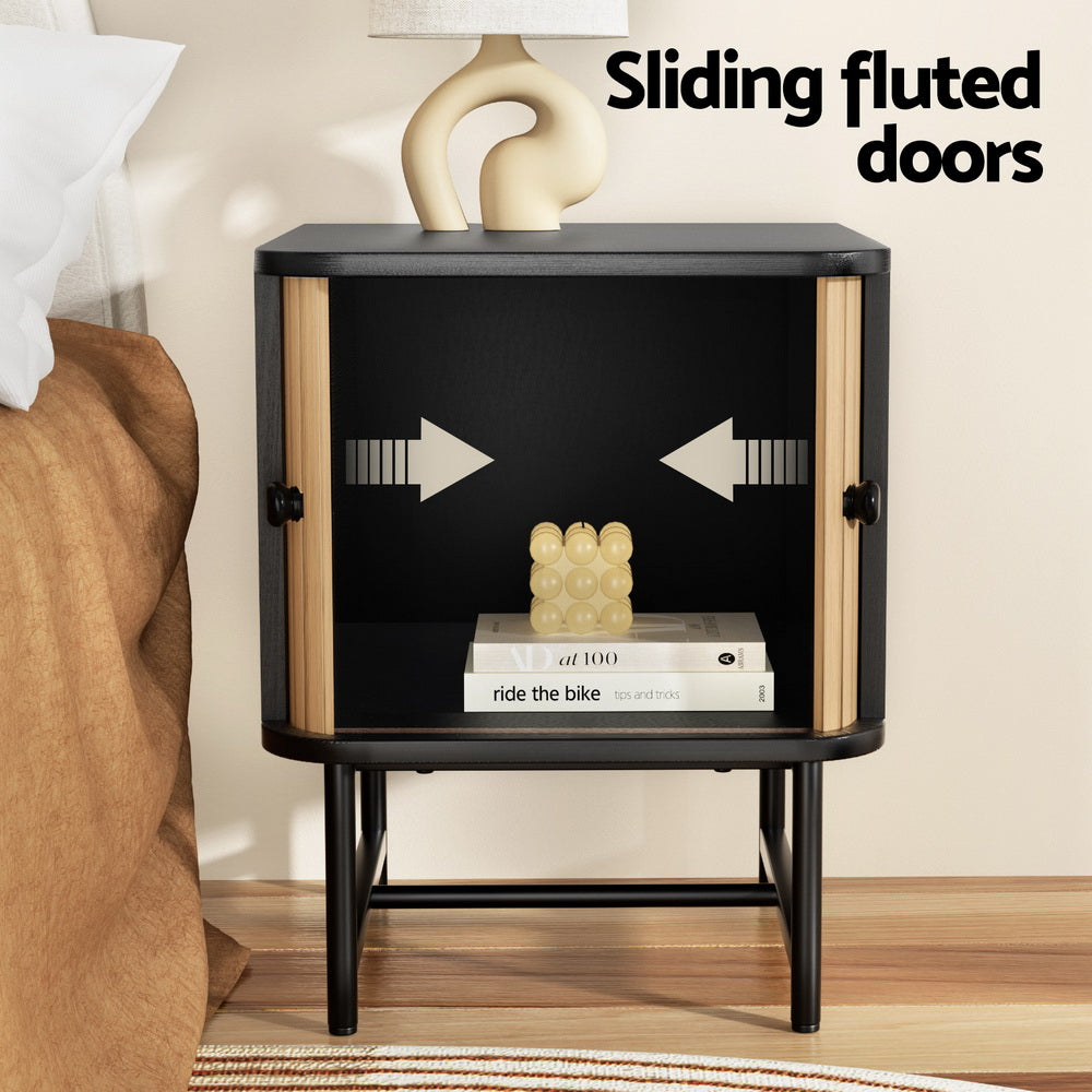 Bedside Table with Sliding Fluted Doors – Black & Pine Finish featuring sliding doors, open storage, and sleek black legs by Bedzy