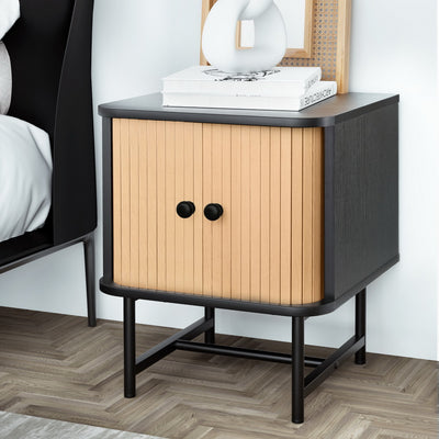 Bedside Table with Sliding Fluted Doors – Black & Pine Finish featuring black frame, pine sliding doors, and round knobs in bedroom setting