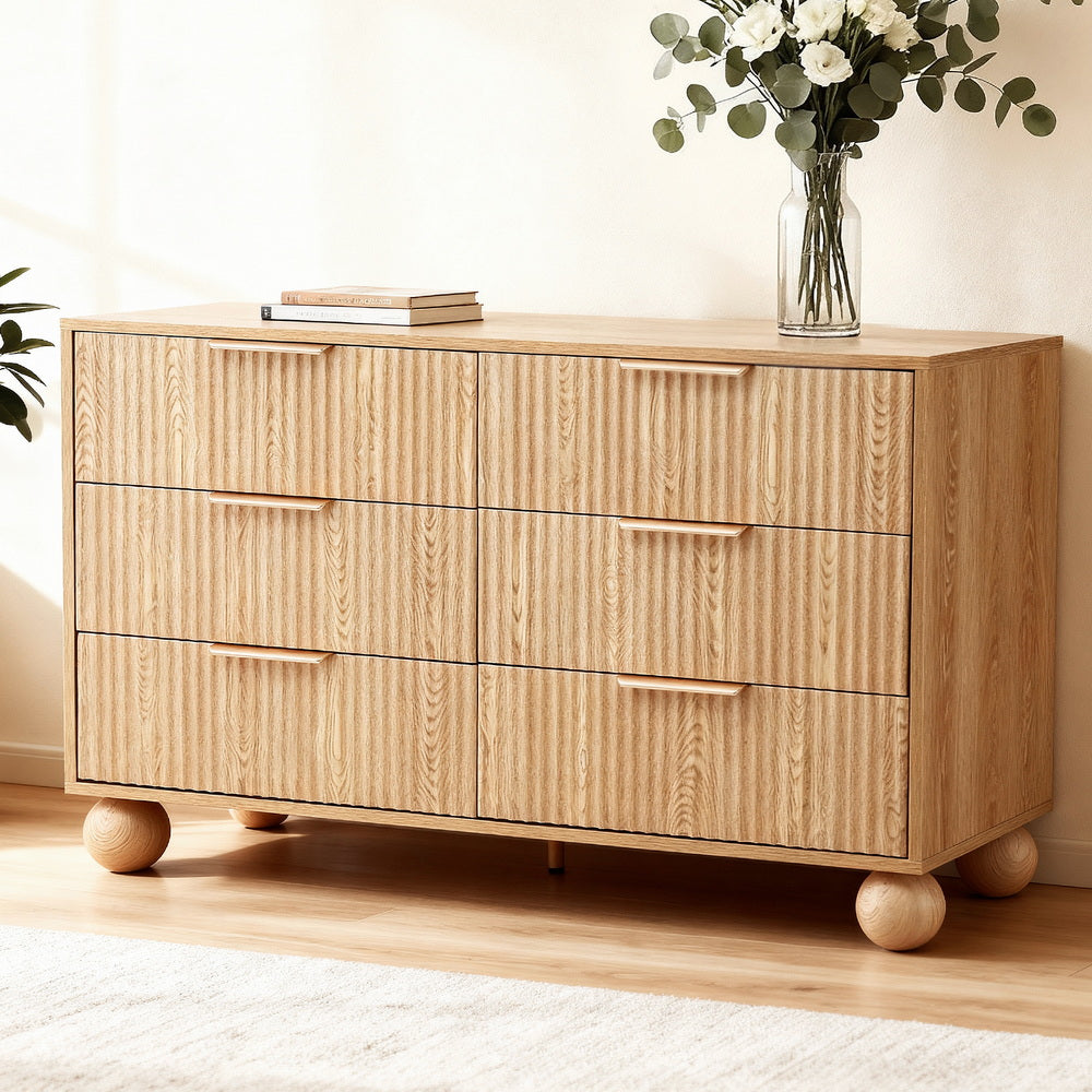6 Chest of Drawers Dresser Tallboy Pine with fluted front, round wooden legs, and sleek horizontal handles in a bright room setting