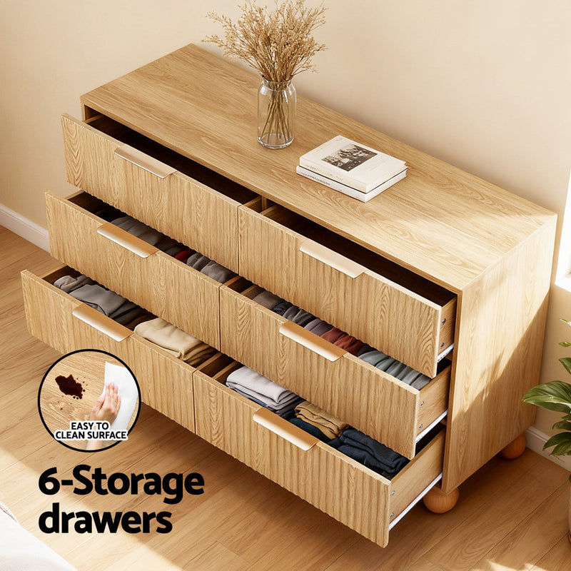 6 Chest of Drawers Dresser Tallboy Pine with six storage drawers, metal handles, and fluted-style front in bedroom setting