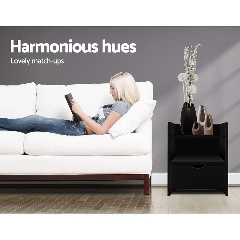 2X Bedside Table 1 Drawer with Shelf - FARA Black next to white sofa, styled with decorative vases and plants in modern bedroom setting