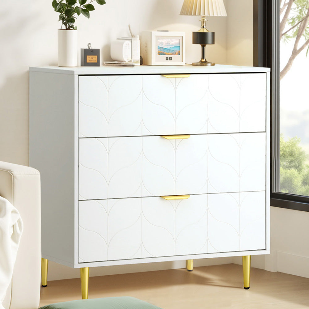 White 3-Drawer Chest of Drawers – Carved Pattern Tallboy with gold handles and legs, styled in a bright bedroom setting
