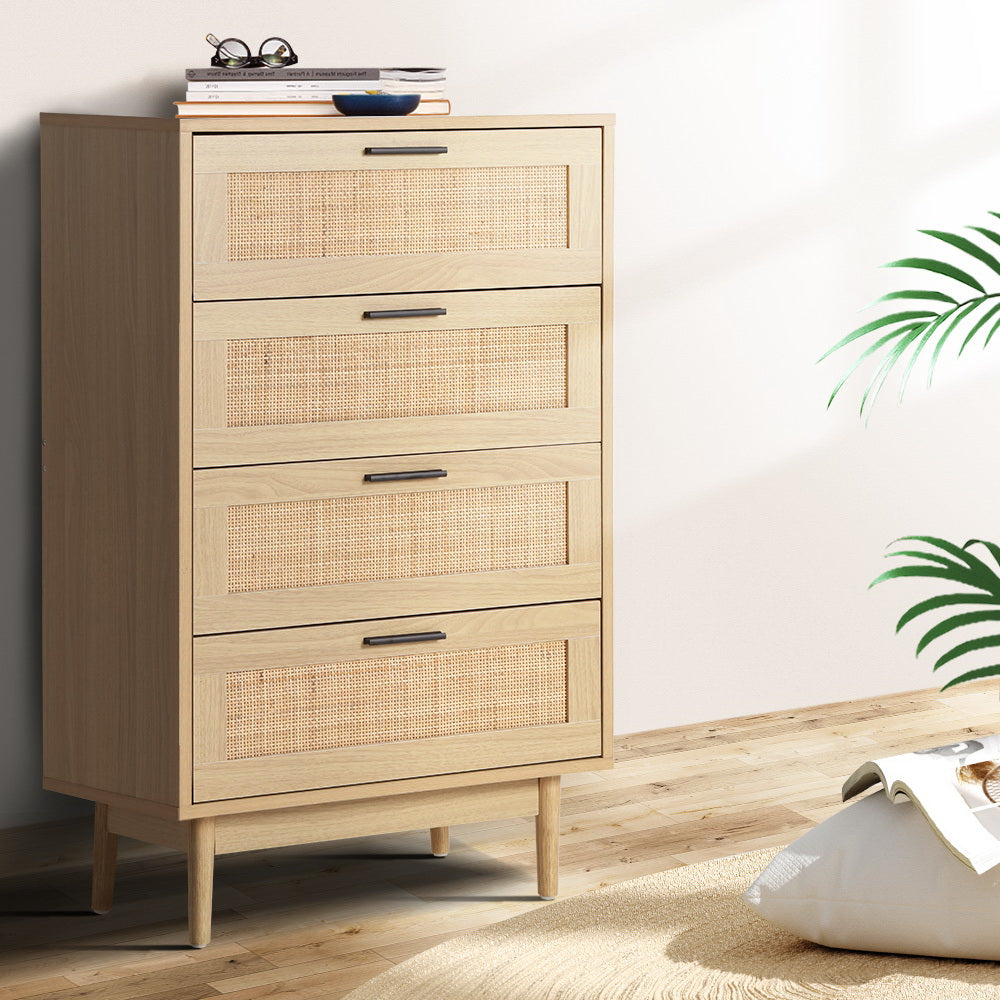 Rattan Tallboy Cabinet With 4 Drawers in oak finish, featuring woven rattan fronts and slim angled legs in a bedroom setting.