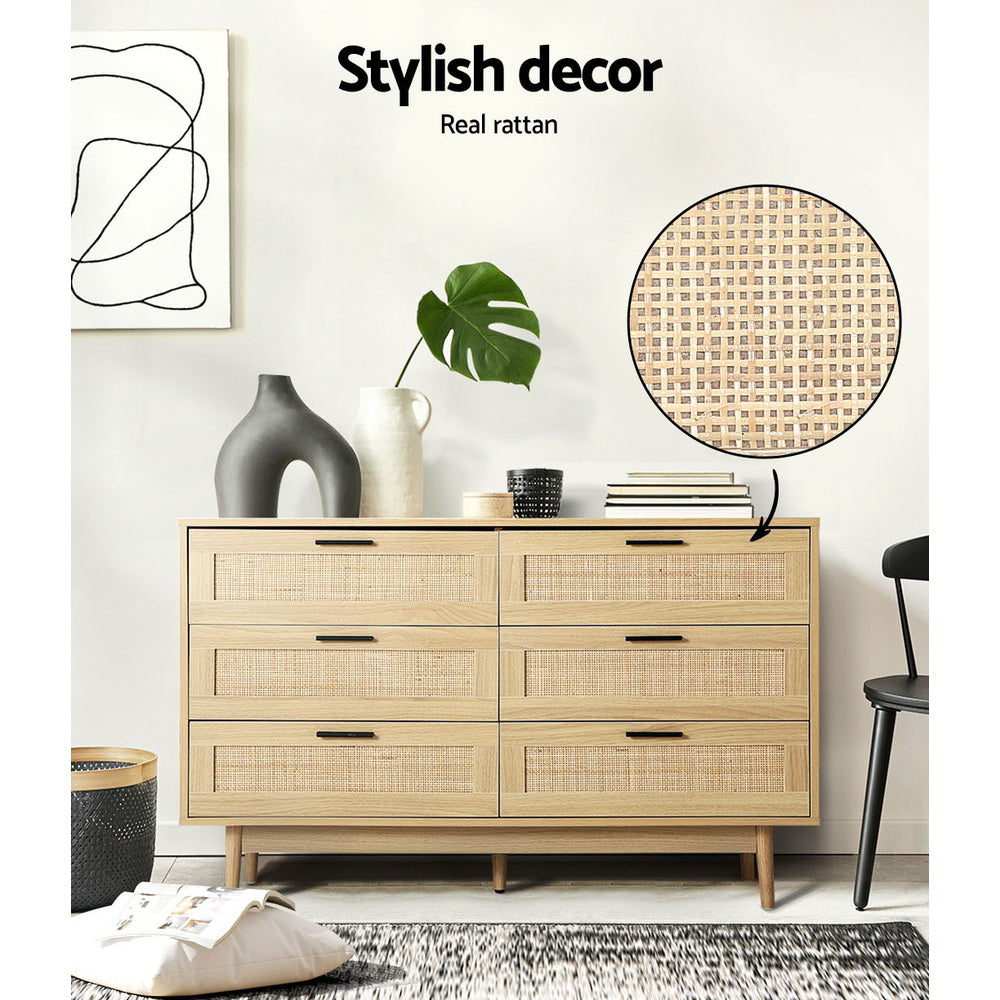 Rattan Tallboy With 6 Drawers in oak finish with woven rattan drawer fronts, styled in a modern bedroom setting with decor items