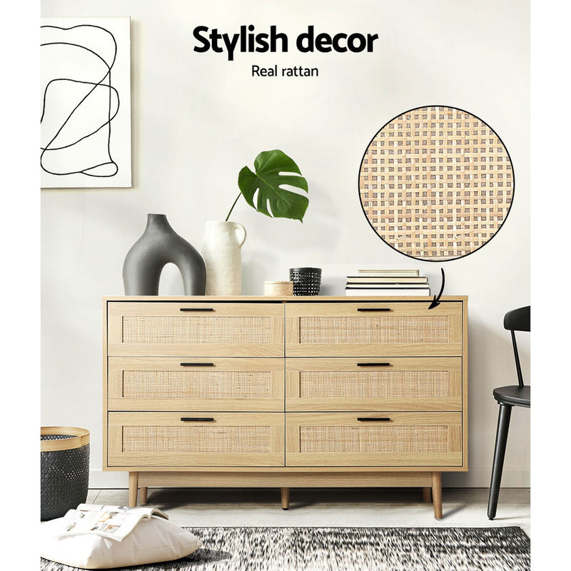 Rattan Tallboy With 6 Drawers in oak finish with woven rattan drawer fronts, styled in a modern bedroom setting with decor items
