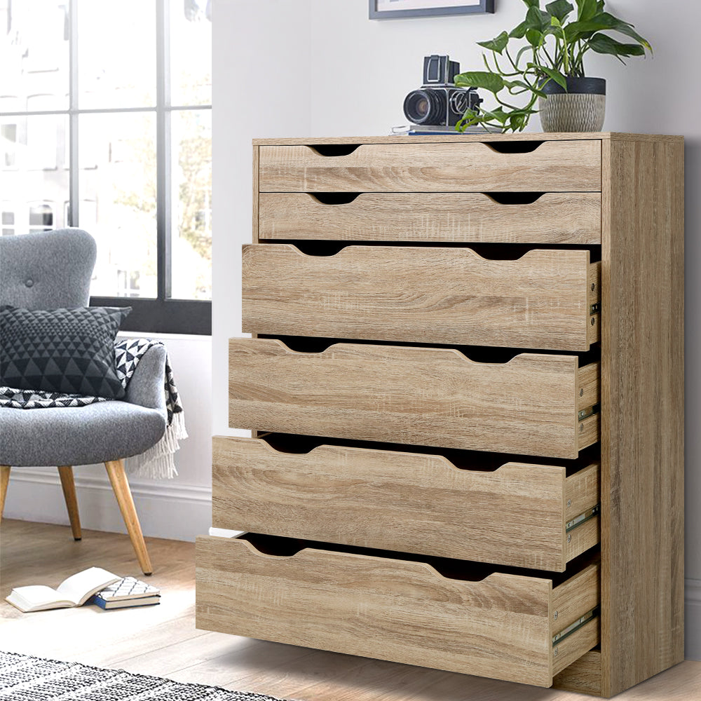 6 Drawer Tallboy Storage Dresser Oak with two shallow and four deep drawers in a bright bedroom setting with decor.