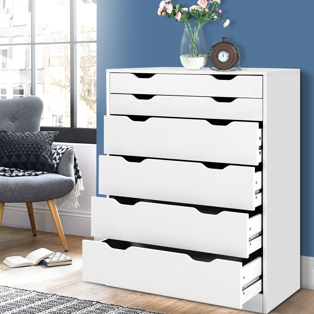 6 Drawer Tallboy Storage Dresser White with modern cut-out handles in a bedroom setting with decor on top and a chair nearby