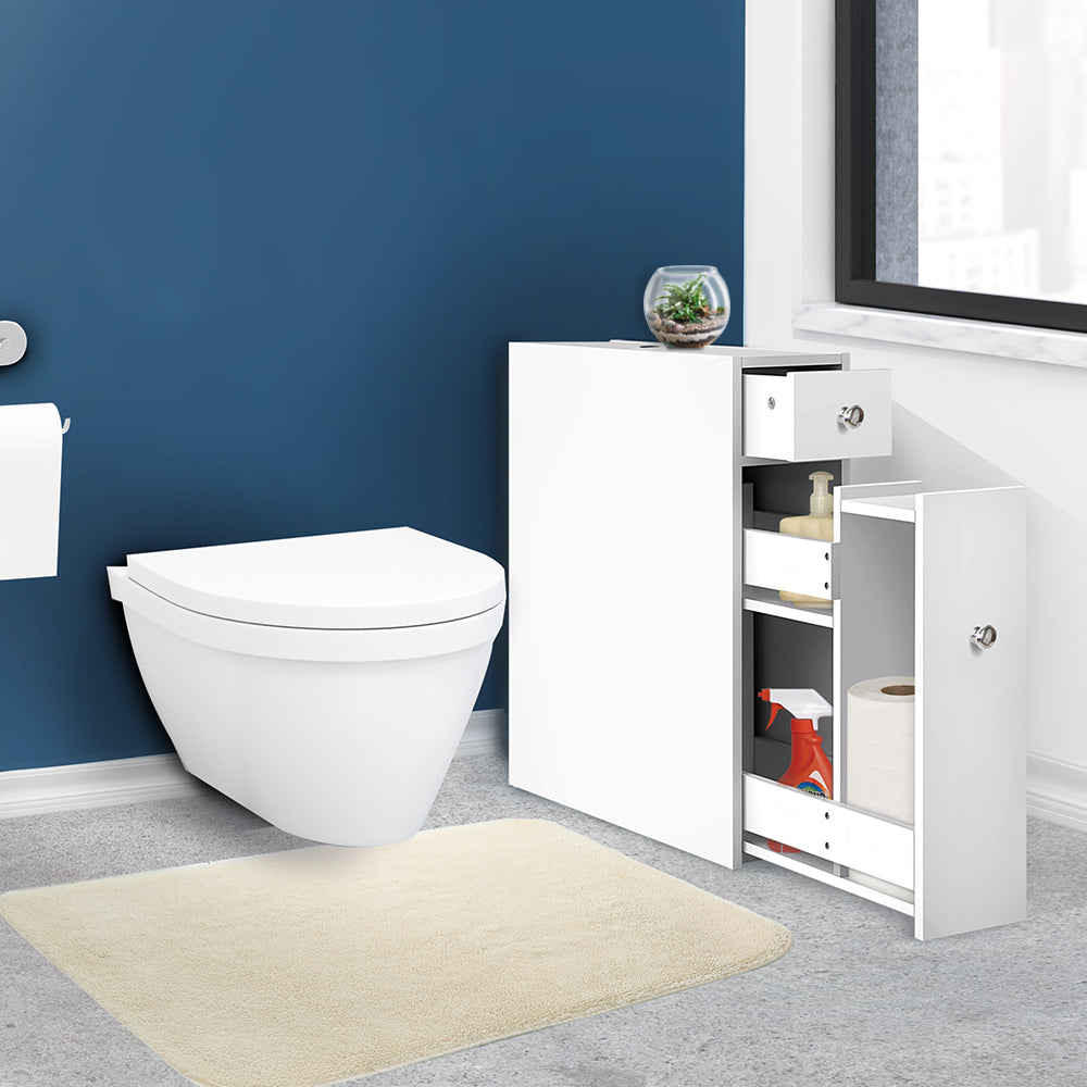 Bathroom Storage Cabinet Tissue Holder in white with open shelves and drawer, placed next to a wall-mounted toilet on blue wall background