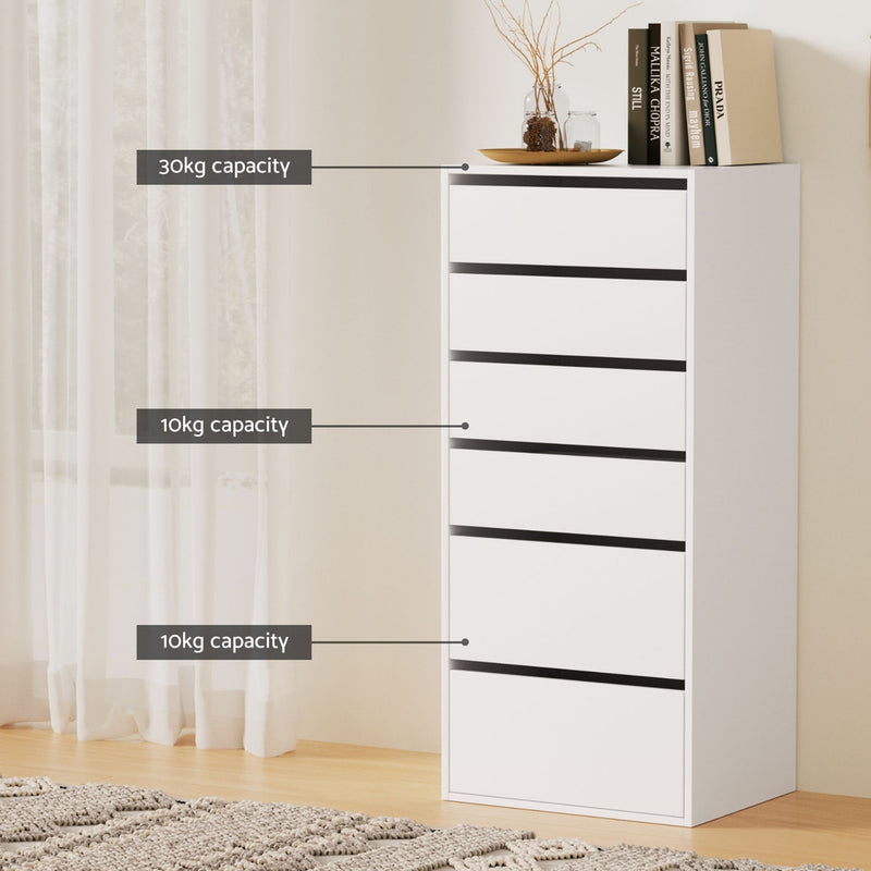6-Drawer Tallboy Cabinet - White with clean lines, multiple drawers labeled by weight capacity, styled with books and decor on top